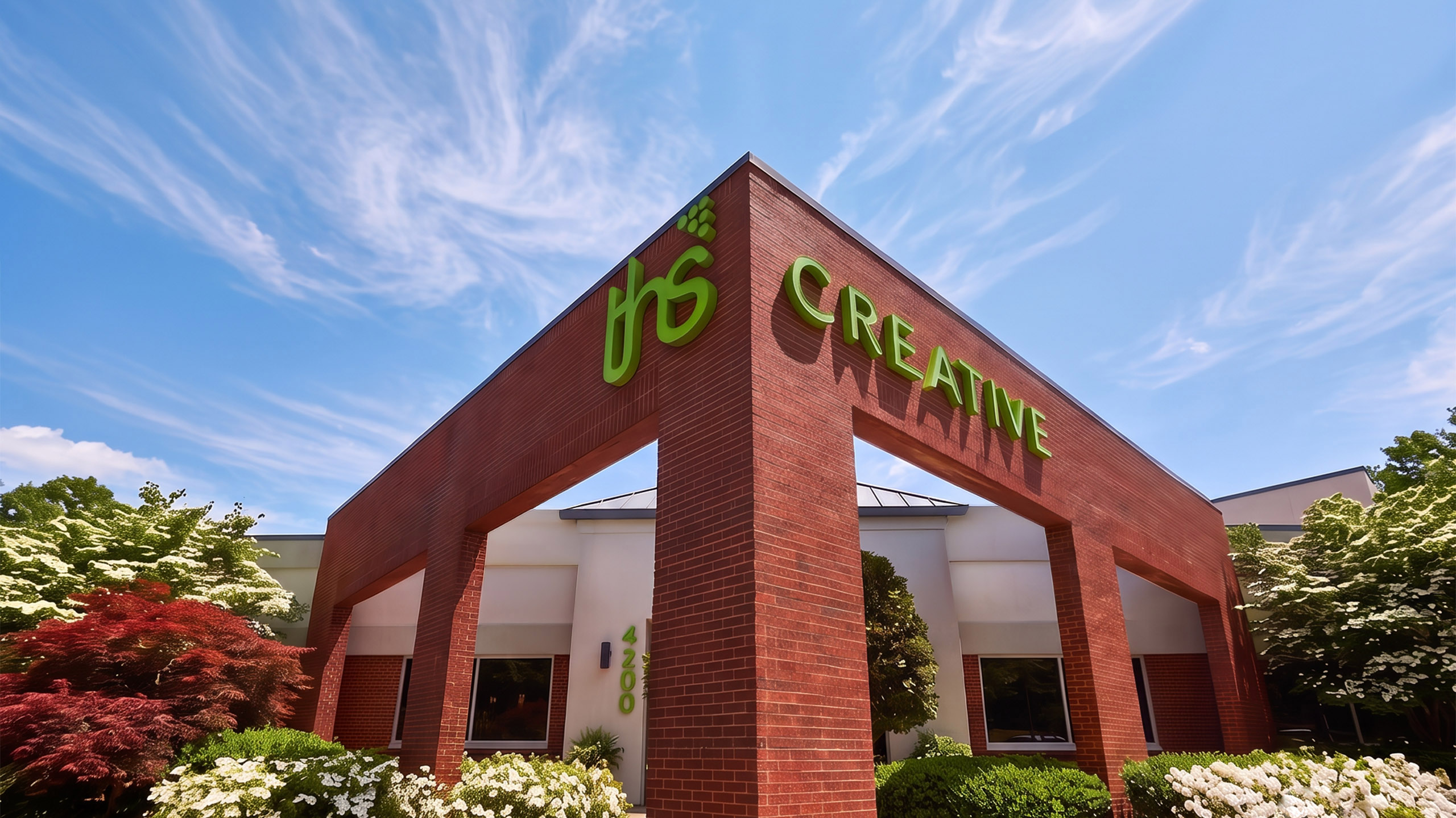THS Creative building entrance archway in Greensboro, NC, under a blue sky